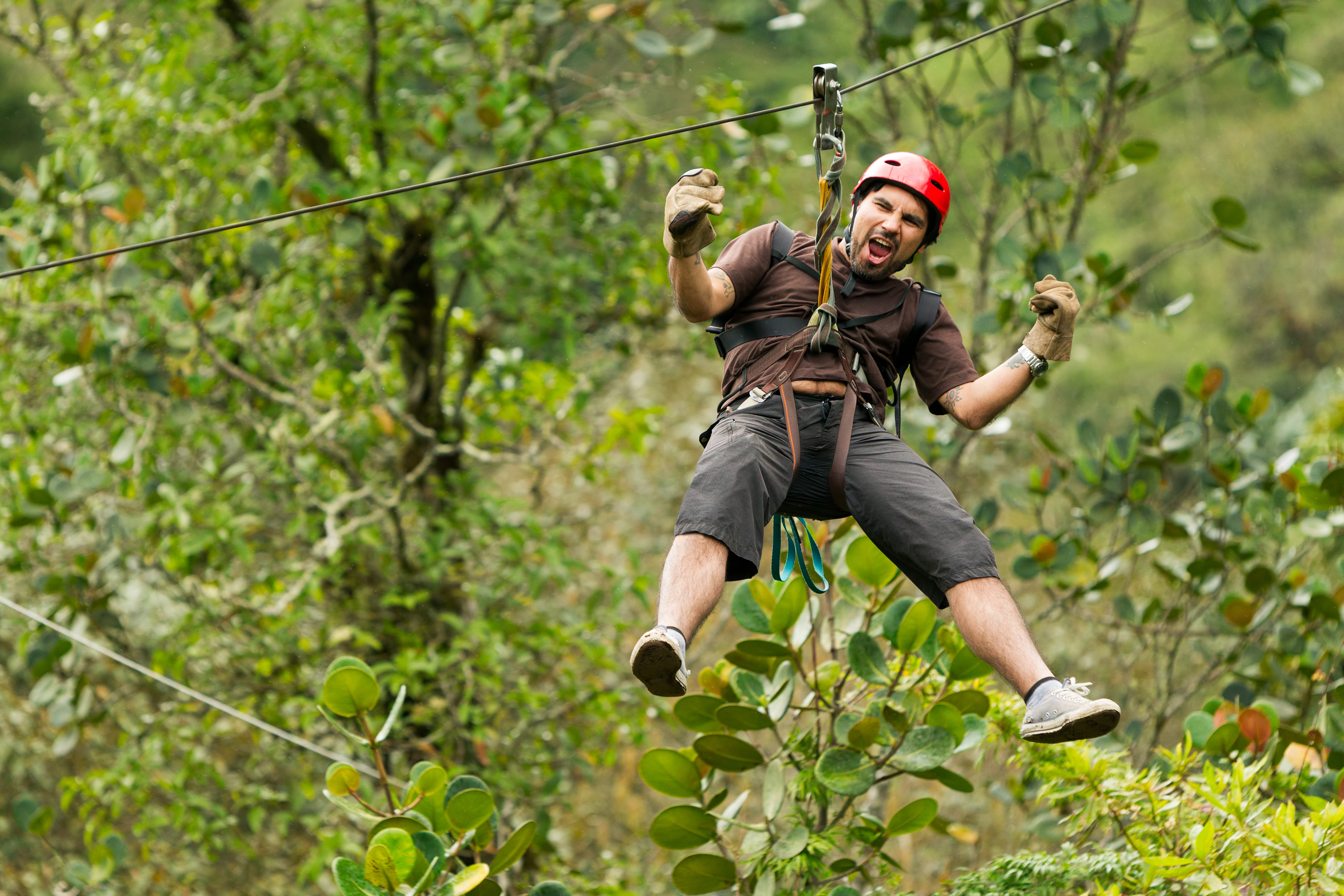 Excited man zip lining